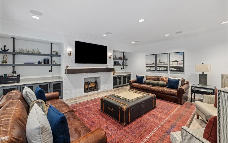 a lounge room with a fireplace