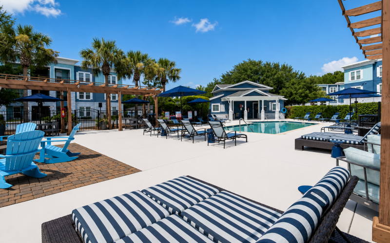 resort-style pool deck with lounge chairs