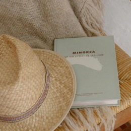 a hat and a book on a blanket