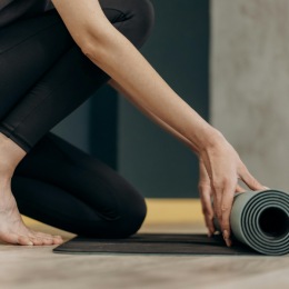 a woman unrolling a mat
