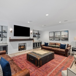 a spacious lounge with a large red rug and ample seating