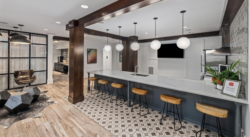 a kitchen with a bar and stools