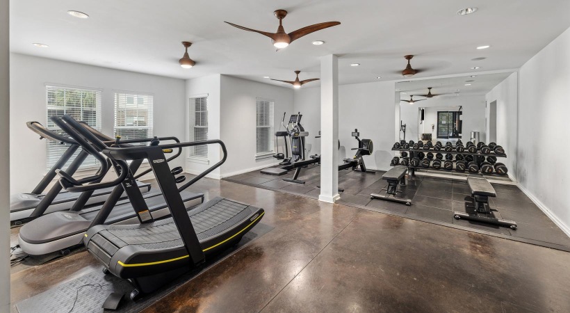 a room with cardio and strength training equipment
