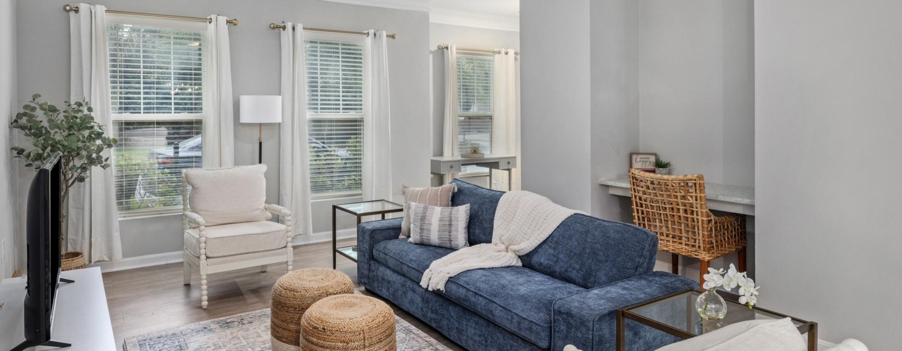 a living room with a couch and a fan